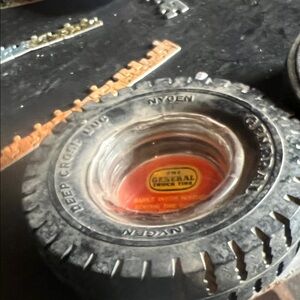 Vintage General Tire Ashtray with Black and Red Design advertisement